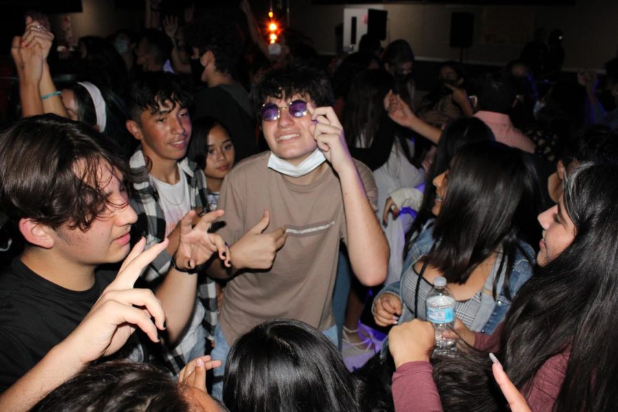 Freshman Angelo Karsouny found himself the center of attention in the middle of the dance floor, surrounded by other freshman students, including Brian Thomas (left) and Jacob Baires (middle).