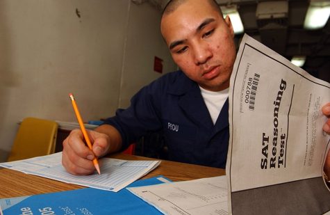 Seaman Chanthorn Peou from San Diego, California, takes his Scholastic Aptitude Test (SAT) aboard the aircraft carrier USS Kitty Hawk, even sailors need to do their SAT!