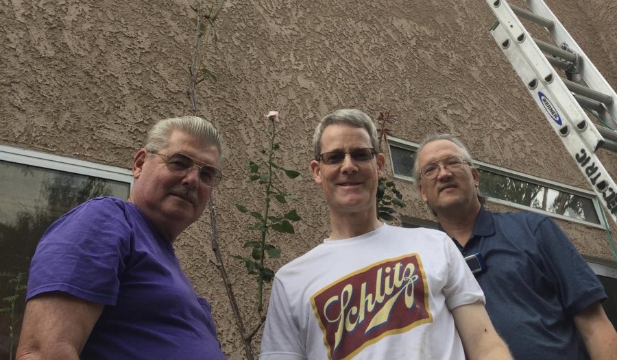 Chris Greenwood, Chris Rose, and Paul Jackson posing in front of Mr. Rose’s 2017 record breaking rose bush standing at 18 feet and 8 inches tall. Photo provided  by Mr. Rose.