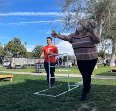 Ms. Sprague and Mr. Janadi playing horseshoe.