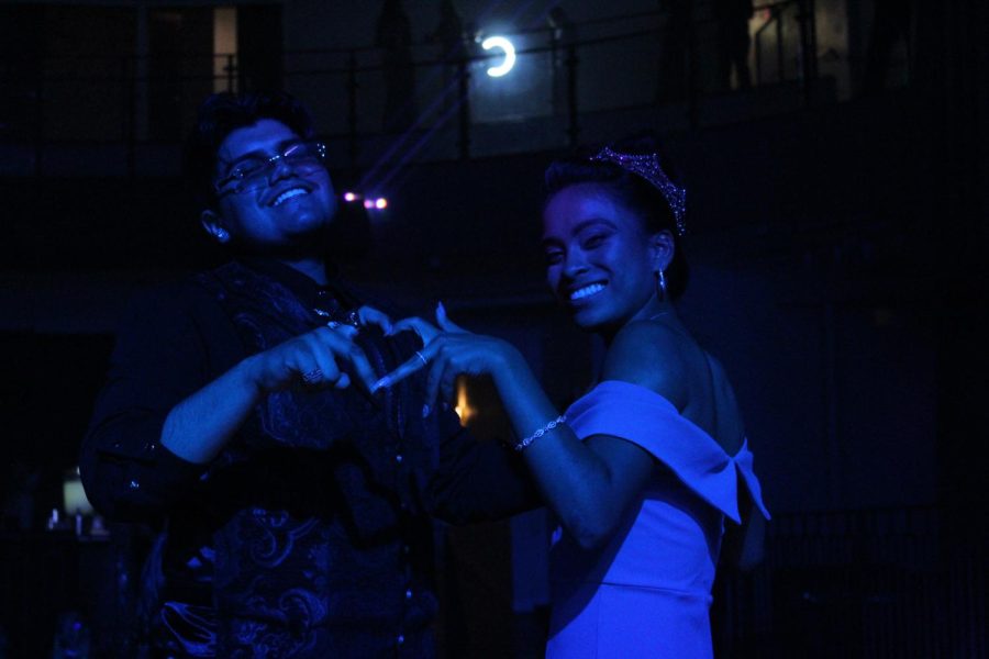Tevin Perez and Royal Monarch Verenia Gonzalez send some love to the camera as they dance on a platform. 