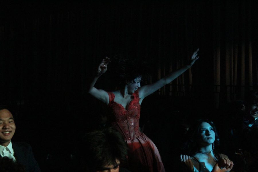 Daniela Arreola dances on a platform as Matthew Tseng and Cassandra Meza enjoy the dance floor. 