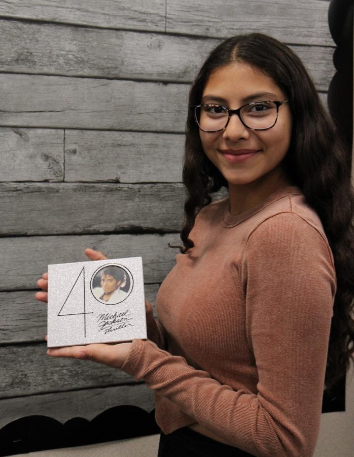 Victoria Romero proudly displaying the Thriller 40 CD.