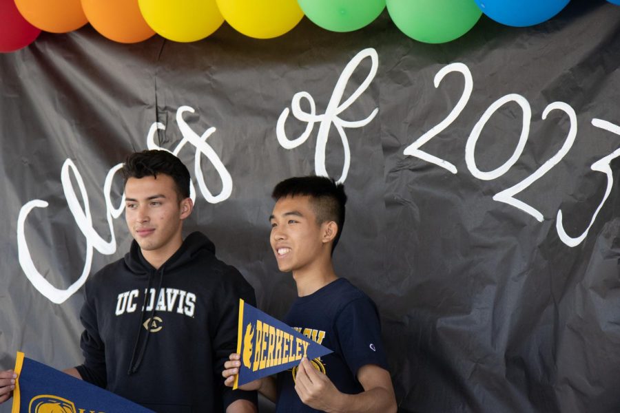 Nicolas Galicia and Jaden Nguyen showing off their college flags.