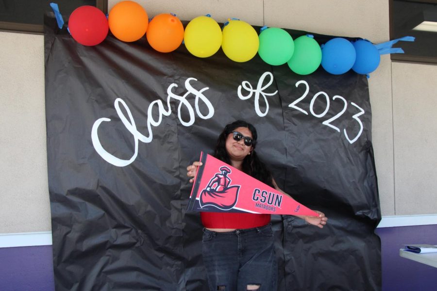 Hannah Ramirez holds up   her CSUN pennant with pride.