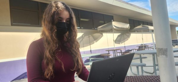 Junior Samantha Soto keeping herself protected from COVID-19 while working on an assignment. 