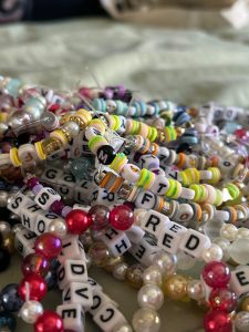 Perea and friends bundle of homemade bracelets before leaving for the Eras Tour.