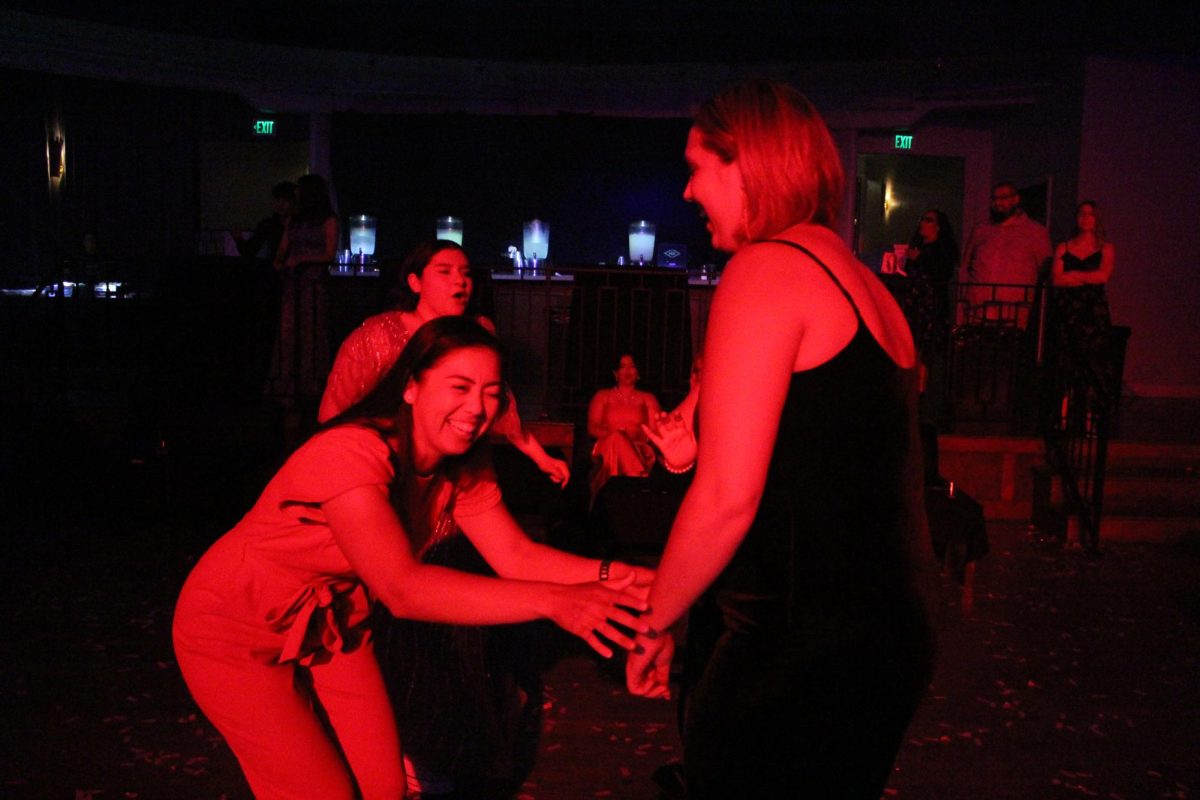 PE teacher Lauren Yao and Elizabeth Hoffman joke and laugh with one another at the very first MECA prom. 