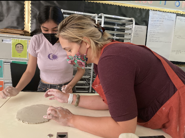 Elizabeth Hoffman shows student Jessica Sanabria ceramics basics in the first year of the Ceramics program.