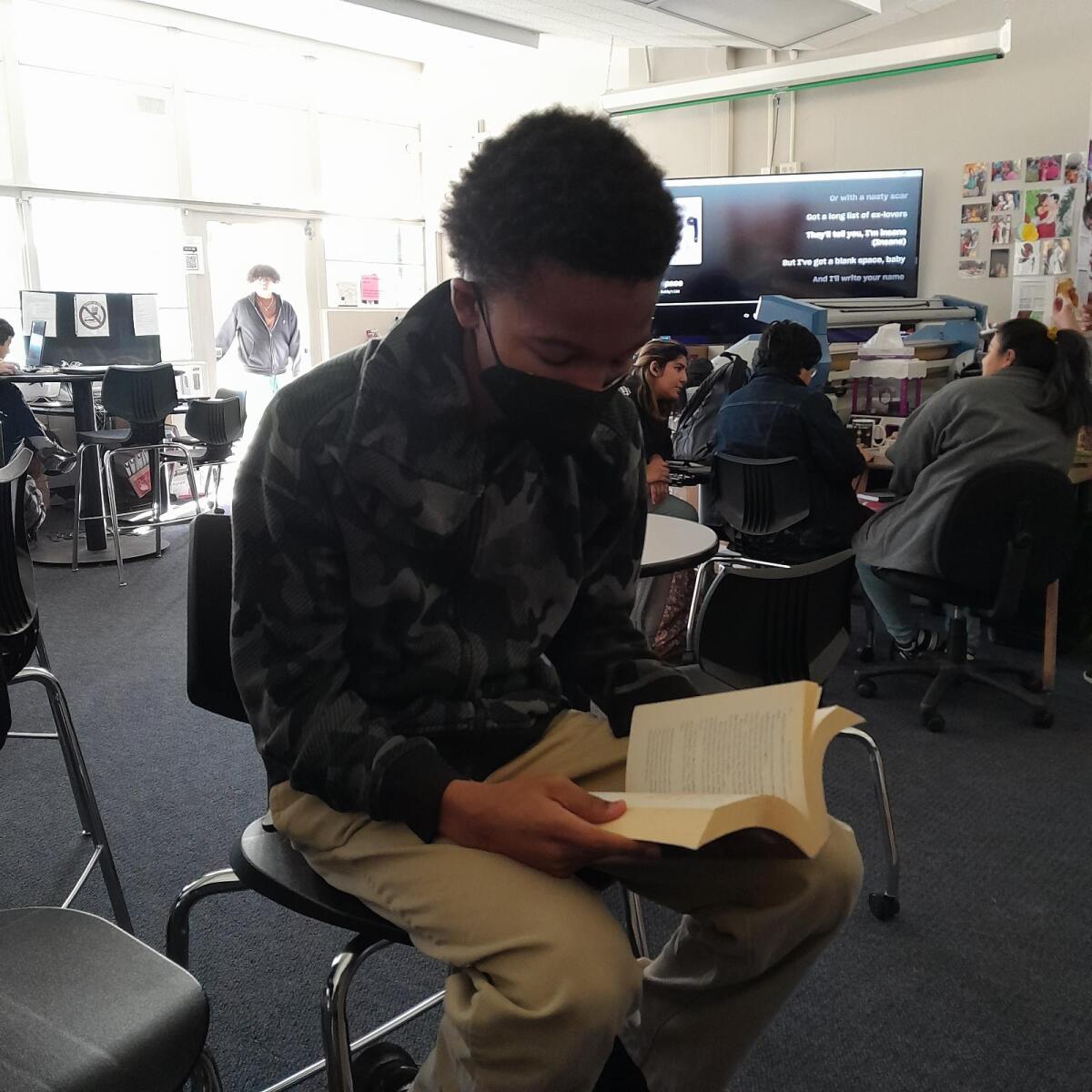 Freshman Dashaughn Bynum reading his book in the media center.