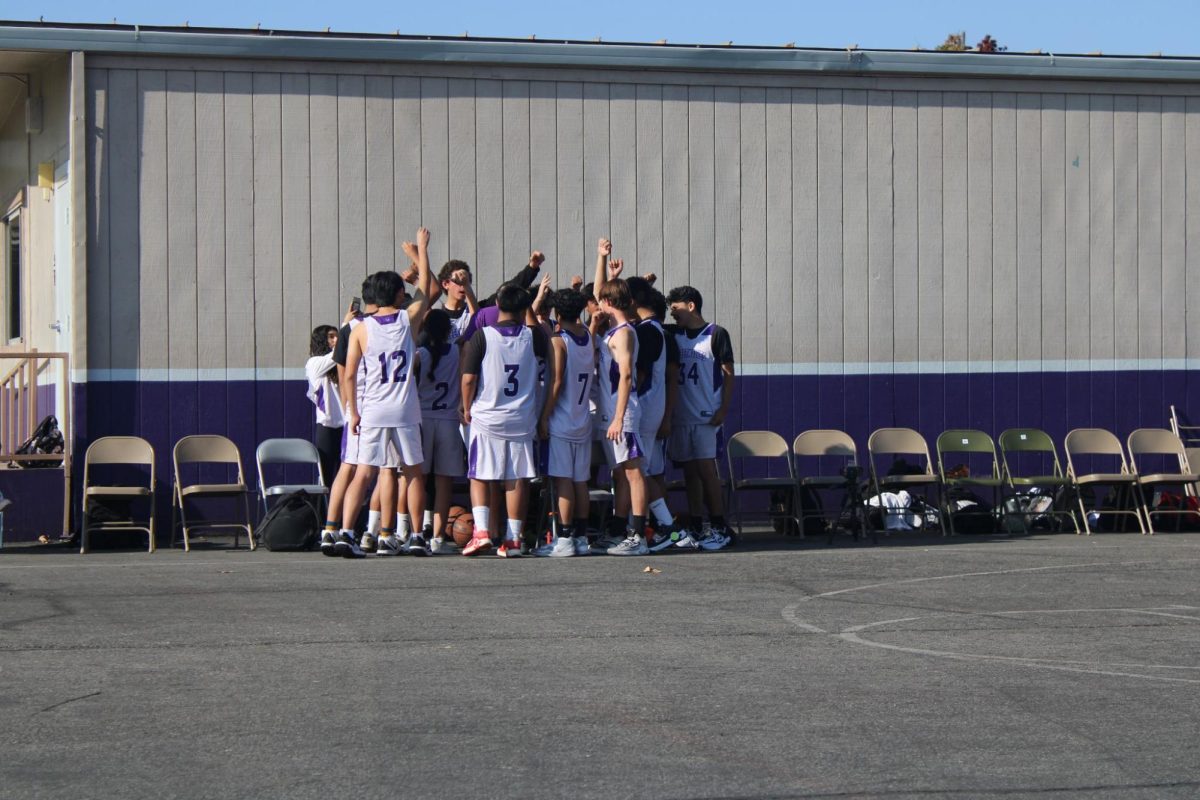 The Basketball Team uniting to defeat their opponents. 