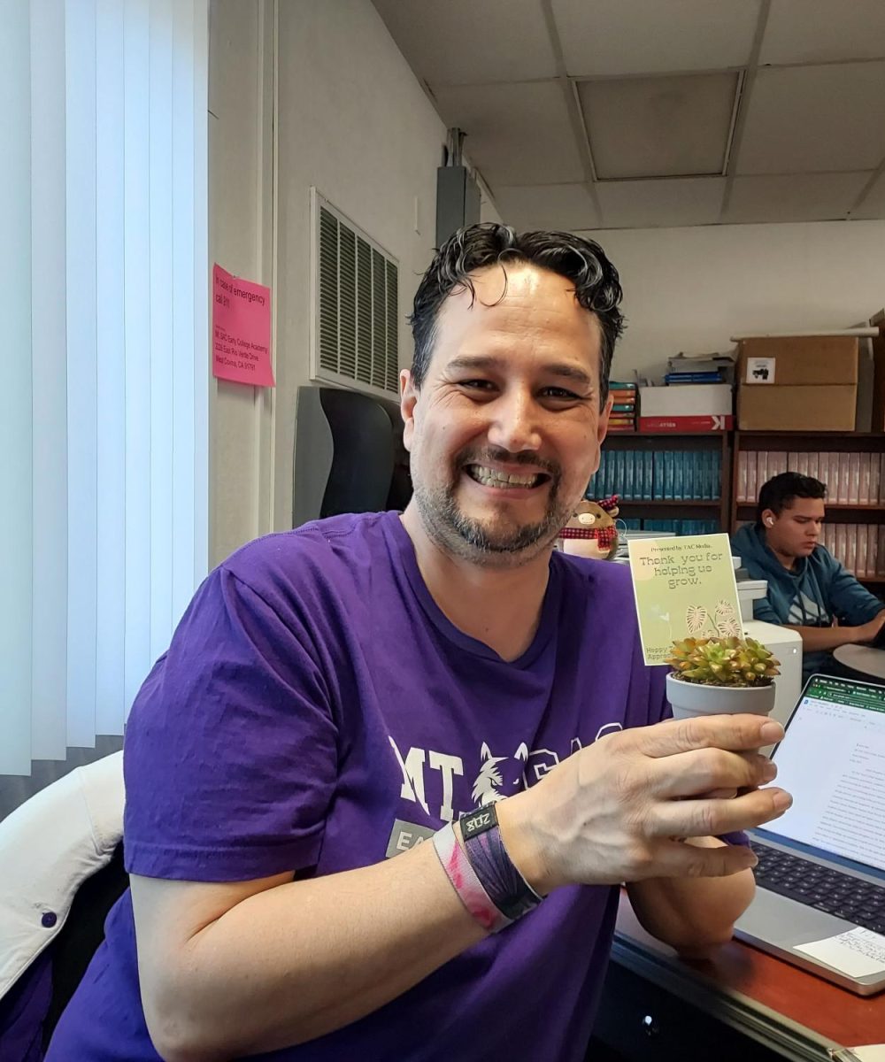 Robert Bobby Sanchez, our Media Center Clerk, smiles broadly with his succulent in the mini media center in room 10. Bobby always makes sure to have a welcoming atmosphere for students during their free periods, at lunch, and before and after school. 