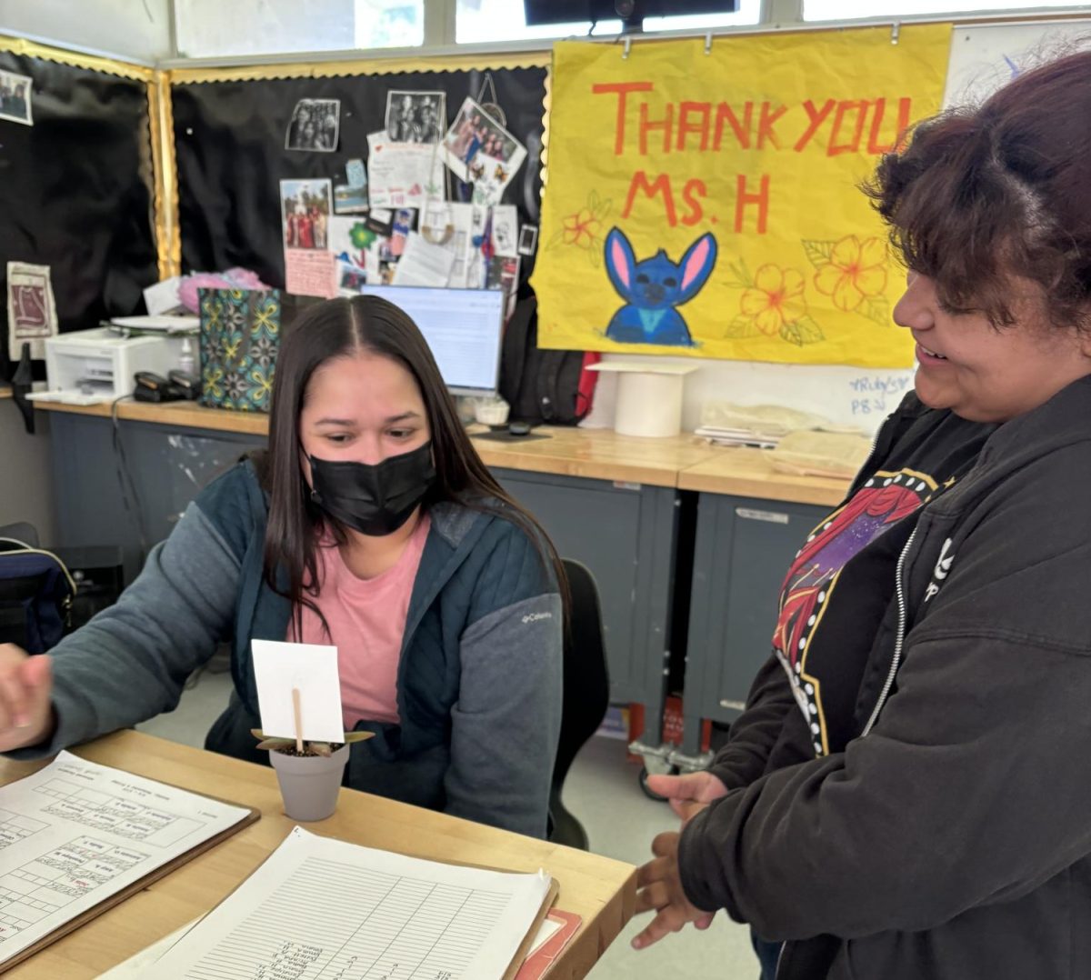 Lydia Higuera looks over the plant with student Gloria Amador; Ms. H, as she is known to the students, watches over the students in Ceramics as they make their masterpieces. 