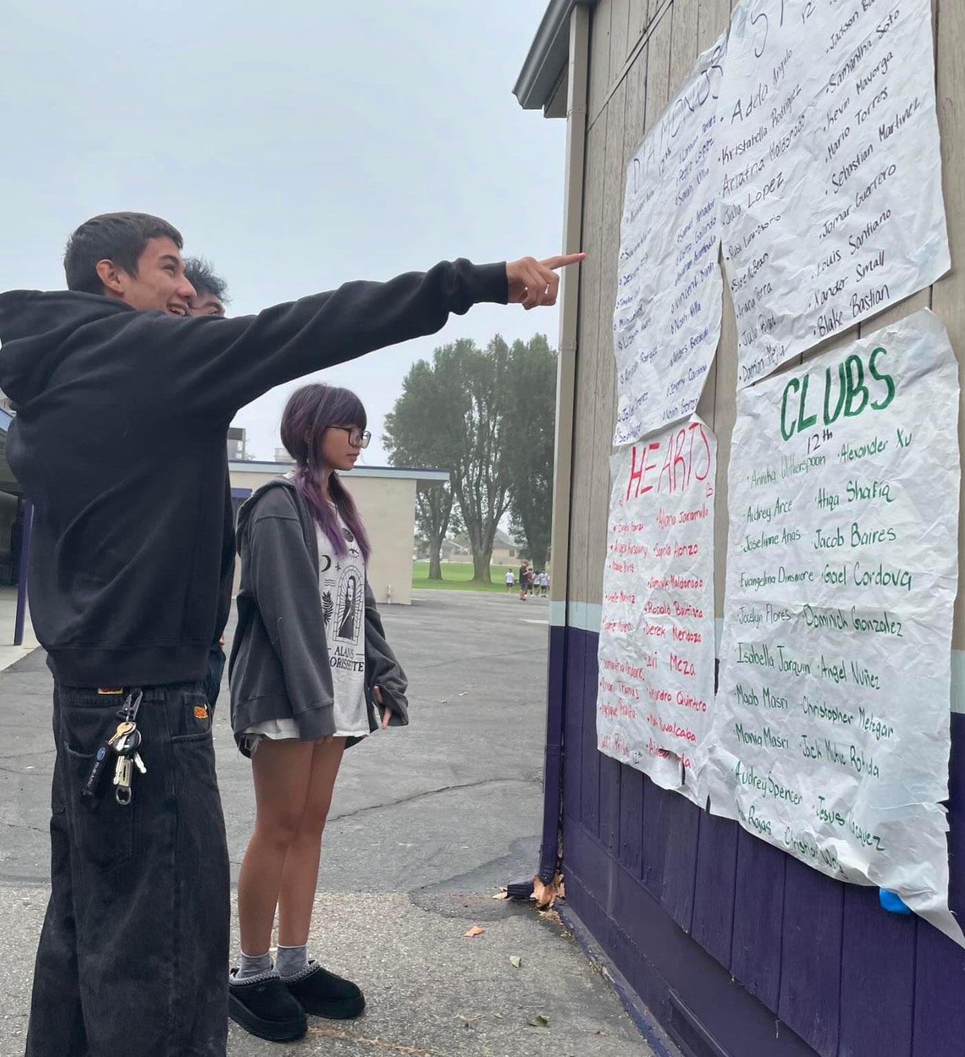 Seniors (left to right) Gabriel Metzgar, Alonzo Galindo, and Ava Rojas excitedly looking at ASB's posters to see which houses they are in. 