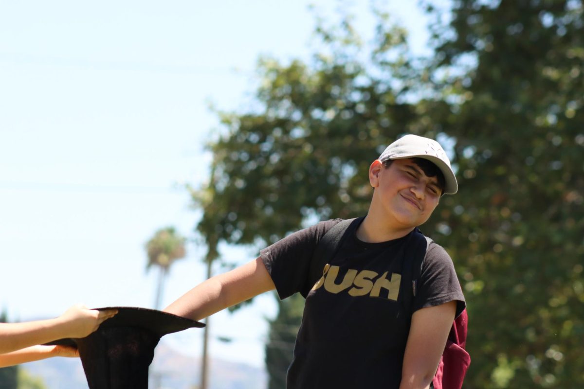 Then freshman, Alexander Fernandez, picks his house from the sorting hat on last year's house sorting day.