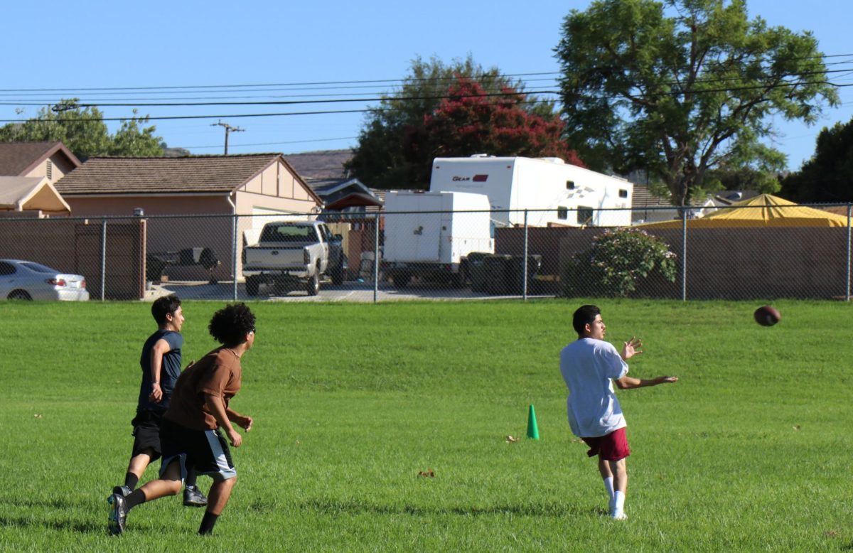 Catch it! Sophomores Andres Bocardo, Brandon Rosales, and Abraham Arambula go for a catch! The three boys practice catching the ball and running with it for flag football.