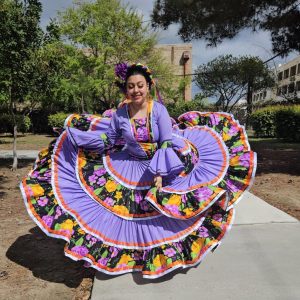 Senior Ariana Parra twirling her dress for the "Como Quieres Que te Quiera" dance as she was rehearsing for her big showcase. Photo provided by Ana Parra