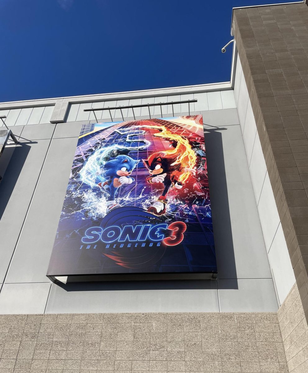 A large "Sonic the Hedgehog 3" poster displayed on the exterior of a local movie theatre.