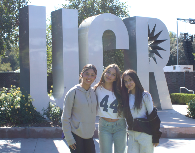 The freshman field trip to the UCR. Cindy Monjaraz (9) and her best friends Isabel Fulmer (9) and Delaylah Gamarra (9) are in front of the UCR sign at the hub inside the University of California, Riverside.