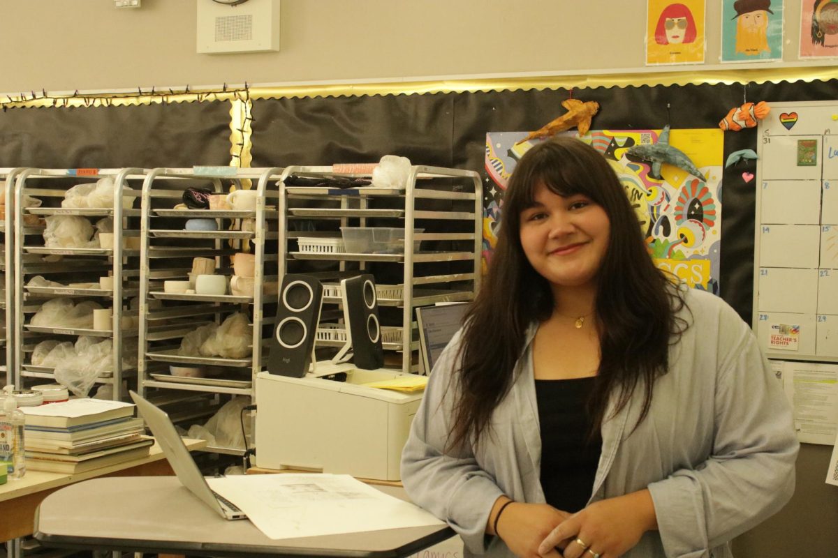 The new art teacher, Samantha Lujan poses for a photo in her classroom.
