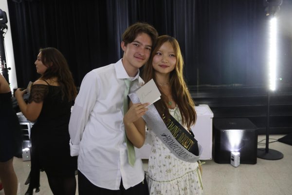Junior Katelyn Chung and sophomore Ethan Bymaster celebrate after Chung was announced as Homecoming Princess.