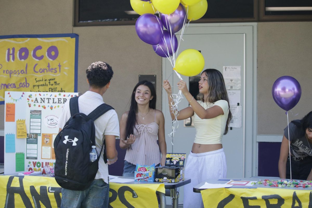 Carlene Virgen (11) and Cindy Monjaraz (10) set up their booth.
