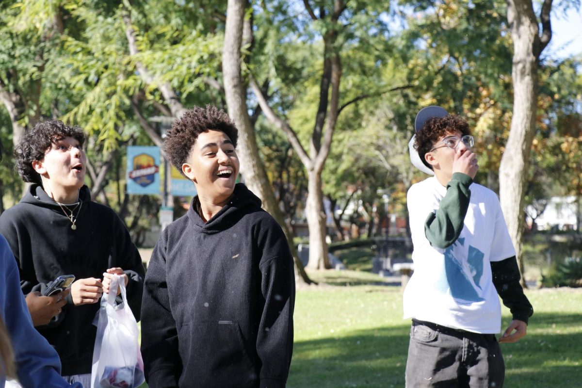 Shocked and full of laughter, Brandon Rosales (10), Elijah Venegas (10), and Brandon Dimian (10) watch as others play with the winter snow at Mt. SAC.