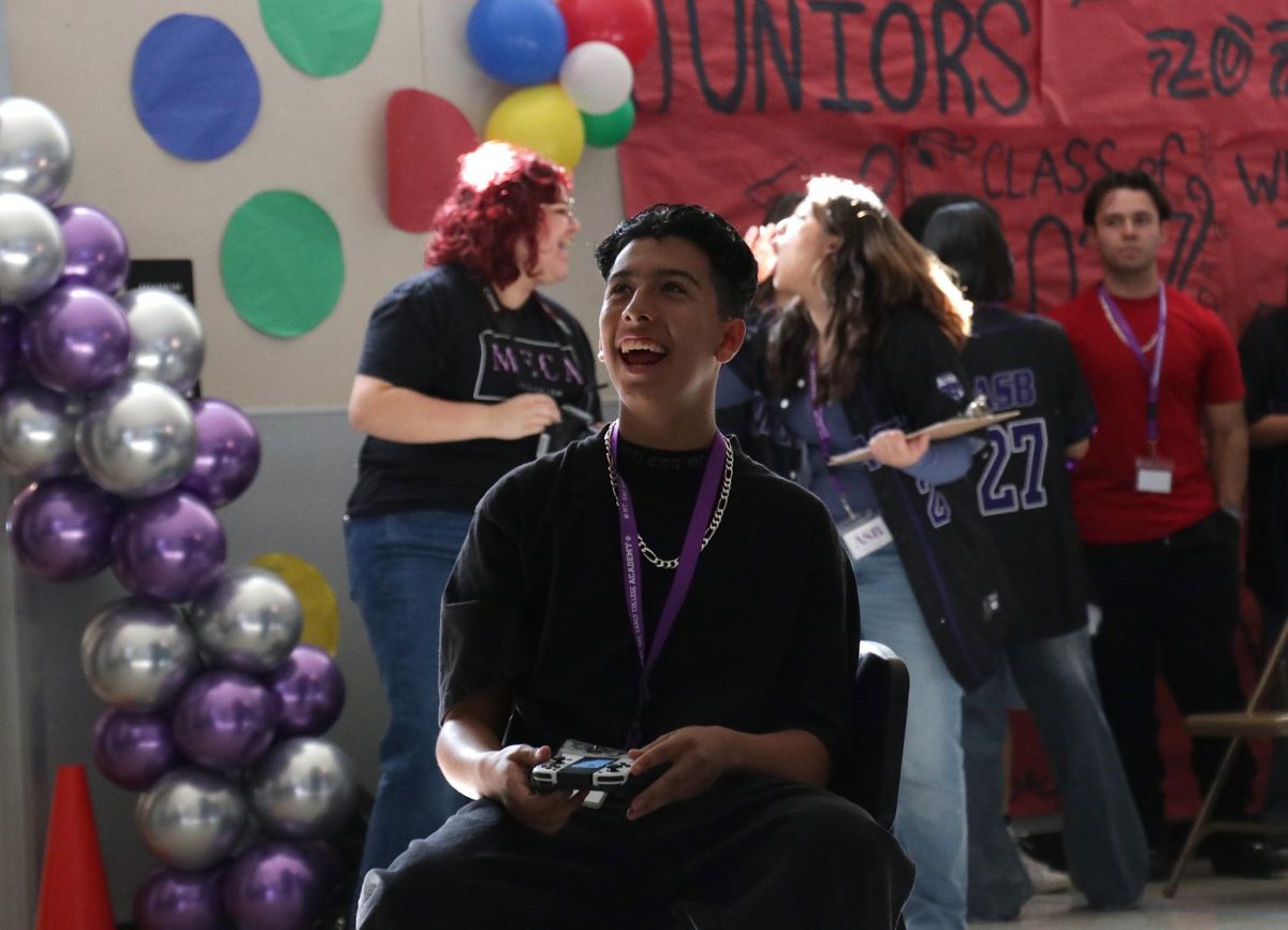 Freshman JC Romero participates in a Mario Kart game during the Renaissance Rally.