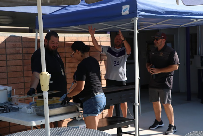 Matt Johnson (P.E teacher), Alex Palacios (security guard), Gabe Nichols (history teacher) and volunteer at MECA, help with Pancake Breakfast.