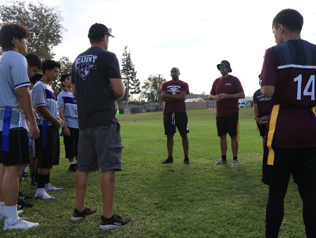 Albert Martinez (10), Steven Narido( 10),  En Hao Xie (11), and coach Gabe Nichols  all huddle around to discuss game rules with Coronado High School.