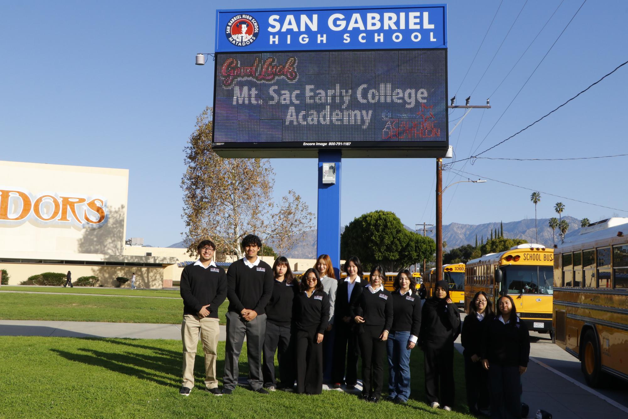 Anthony Reyes (12), Tepotchli Cervantes (12), Dulce Chacon (12), Thearose Garcia (12), Katelyn Chung (11), Karren Zhuang (11), Mckenna Chung (10), Genevieve Hijar (11), Hazel Shafiq (11), Jocelyn Lee (11), and Michelle Calinisan (11) pose for a group photo in front of San Gabriel High School. 