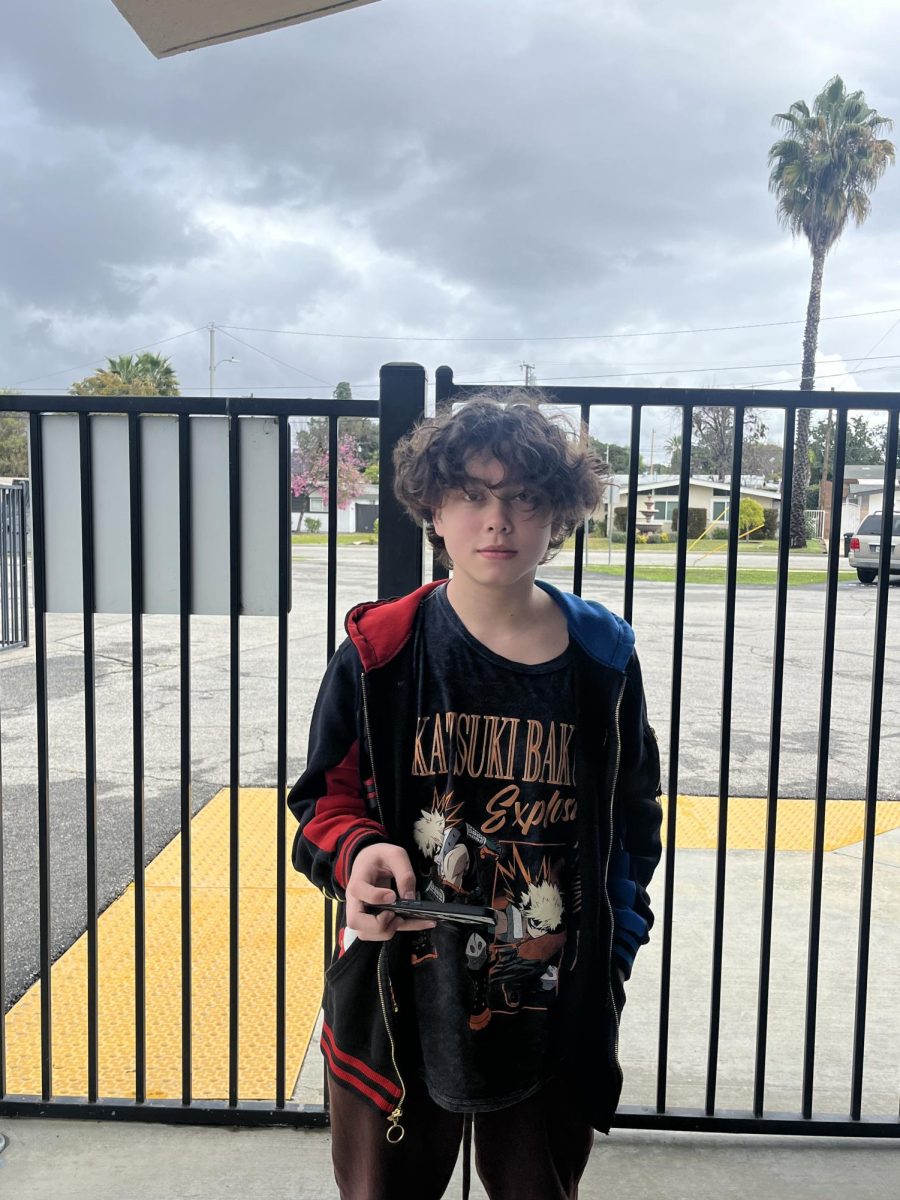 Carlos Miguel Hombrebueno standing in front of the school gate.
 