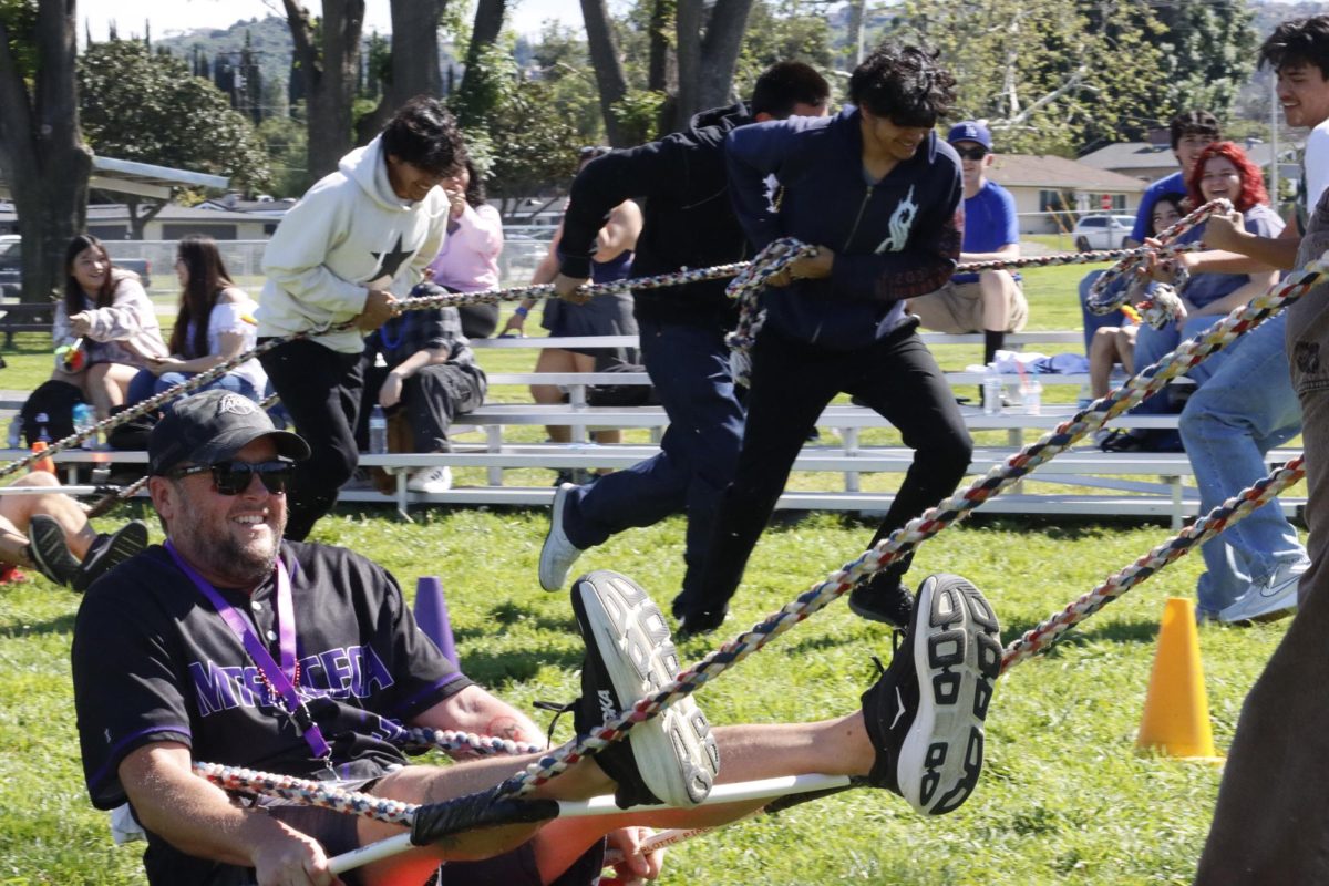 Gabe Nicholas enjoys the dogsled games as he is pulled by the sophomores.