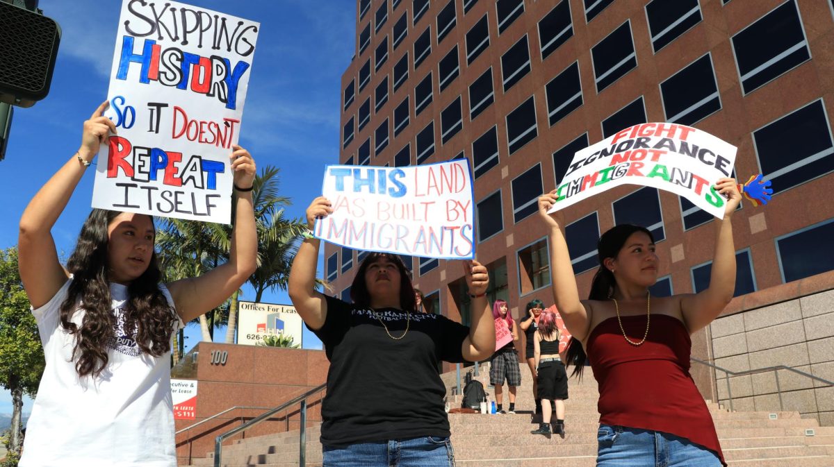 Samantha Perez (9), Yenely Ortiz(9) and Emma Tavera (9) on the stairs holding up their posters that was created to protest against "ICE"."