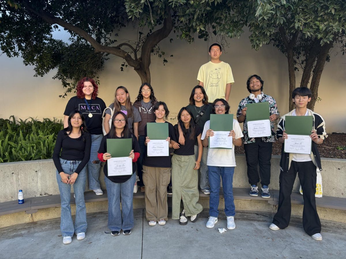 After the competition Desiree Vasquez (11), Autumn Pagan (12), Jocelyn Lee (11), Leyna Tran (10), Iliana Maldonado (10), Marisol Barragan (10), Rena Wang (10), Raeka Wang (10), Julian Puente (10), William Liu (10), Joshua Fermalino (12), Jason Li (9) (left to right) pose for a photo. (Image by Courtney Bell)