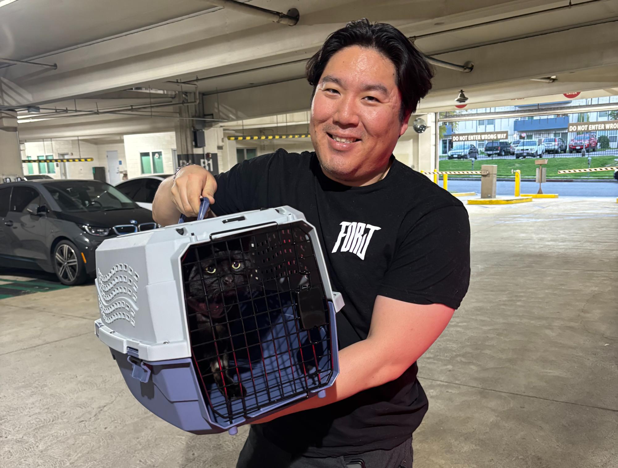 New owner Charles Lee posing with beloved cat Salem.