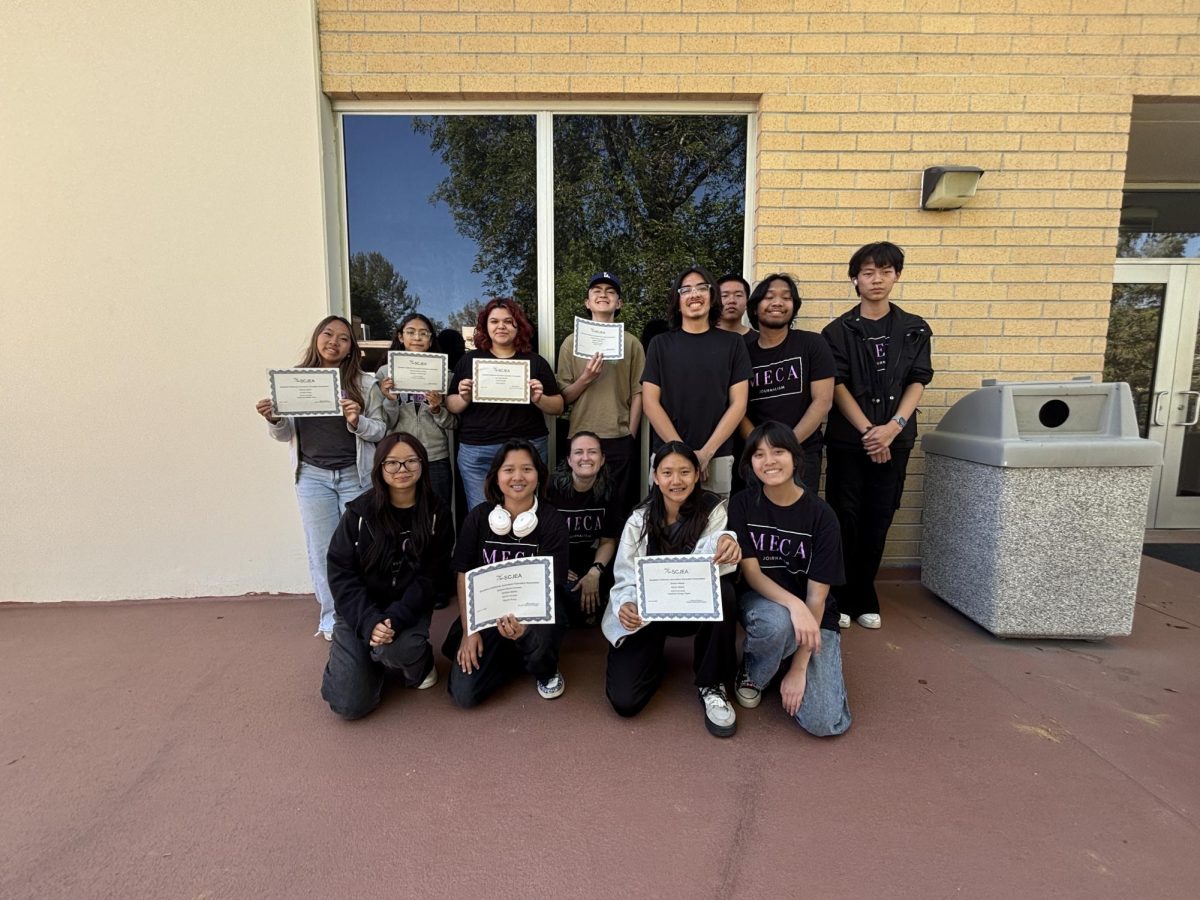 MECA students and Courtney Bell, journalism and yearbook adviser, pose for a photo. Photo credit: Phoebe Chow