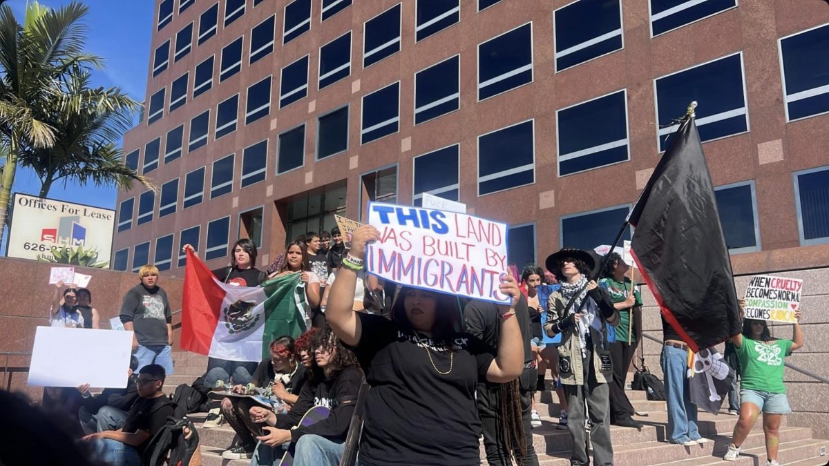 MECA student, Samantha Perez hold up a sign as students from different schools across three different districts protested against the recent ICE activities. Protesters carried signs and flags expressing that ICE should be disbanded and needs to stop what they have been doing to immigrants.