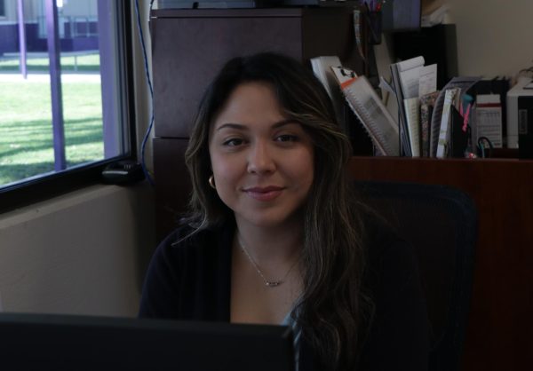 Blanca Avila sits at her desk in the office.