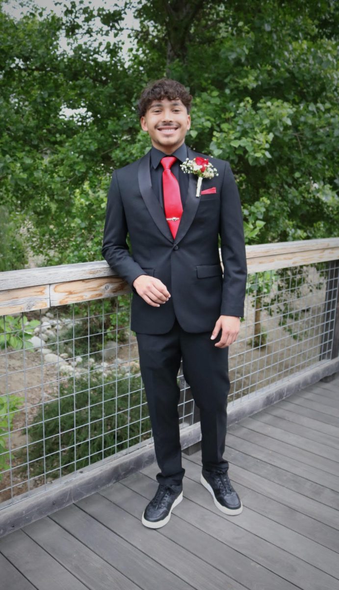 Anthony Reyes (12) posing for a professional photoshoot before his junior year of prom.