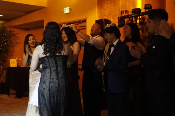 Tara Phapornchai getting crowned as prom queen by Gabe Nichols.