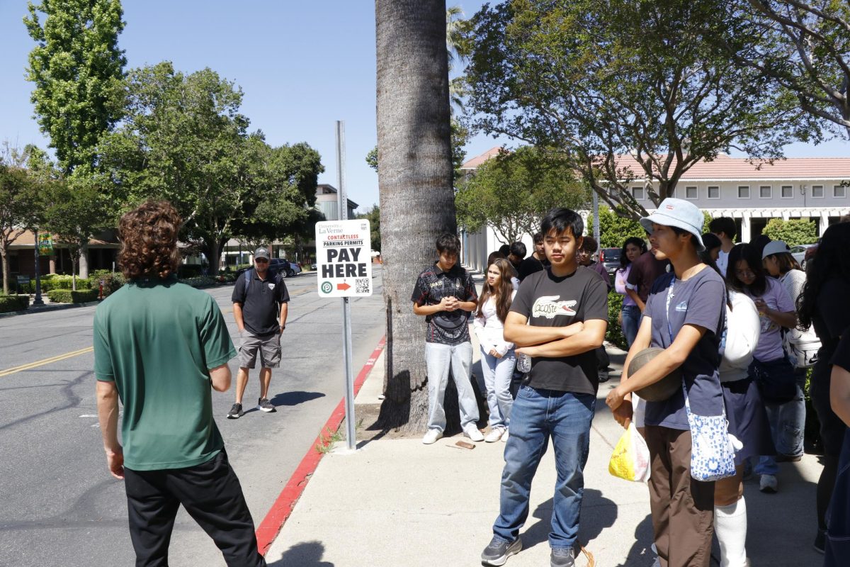 James Phan (10th) and Kyle Cao (10th) listen to the tour guide as he explains what establishments are near the school. The tour group goes around the border of the school, showing what shops and restaurants they have.